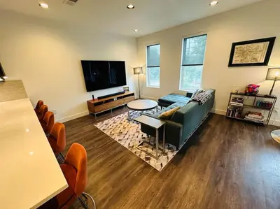 a living room with a couch and a flat screen tv at Downtown Denver Smart House in Denver