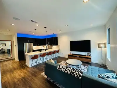 a living room with a couch and a kitchen at Downtown Denver Smart House in Denver