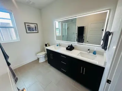a bathroom with a sink and a mirror at Downtown Denver Smart House in Denver