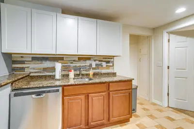 a kitchen with white cabinets and a dishwasher at 9 Mi to Dtwn Denver Aurora Vacation Rental in Aurora