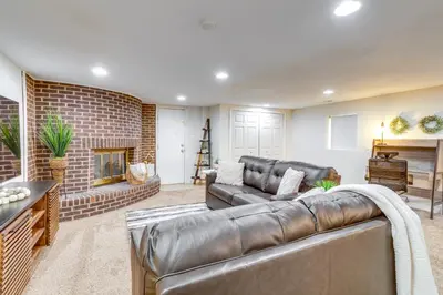 a living room with a leather couch and a fireplace at 9 Mi to Dtwn Denver Aurora Vacation Rental in Aurora