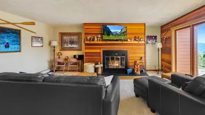 a living room with two couches and a fireplace at Tranquil 2BR Near Trails and Free Shuttle in Silverthorne