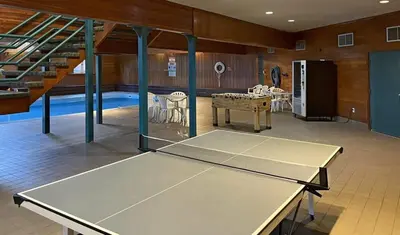 a ping pong table in the middle of a room with a ping pong at Tranquil 2BR Near Trails and Free Shuttle in Silverthorne