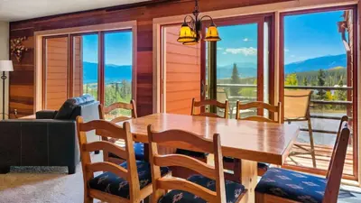 a dining room with a table and chairs with a view at Tranquil 2BR Near Trails and Free Shuttle in Silverthorne