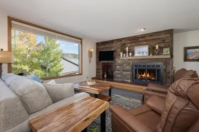 a living room with a couch and a fireplace at Snowblaze A24 condo in Winter Park