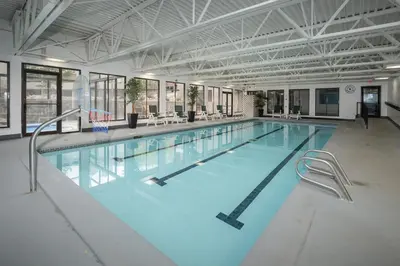 a large swimming pool with blue water in a building at Snowblaze A24 condo in Winter Park