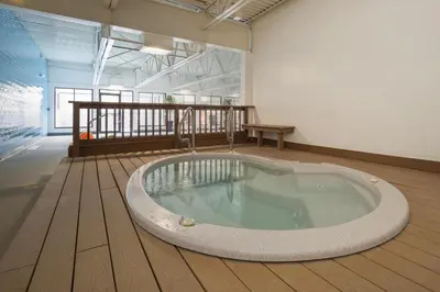 a large bath tub in a room with a wooden floor at Snowblaze A24 condo in Winter Park