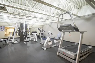 a gym with treadmills and machines in a room at Snowblaze A24 condo in Winter Park