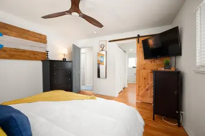a bedroom with a bed and a flat screen tv at Luxury 3b-3b- Hot tub, Sauna, Personal Gym in Denver