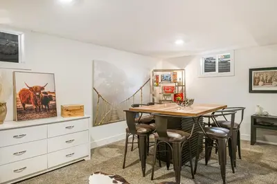 a dining room with a wooden table and chairs at Luxury 3b-3b- Hot tub, Sauna, Personal Gym in Denver