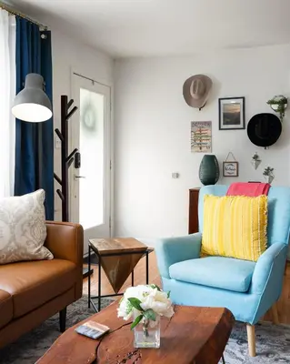 a living room with a blue chair and a table at Luxury 3b-3b- Hot tub, Sauna, Personal Gym in Denver