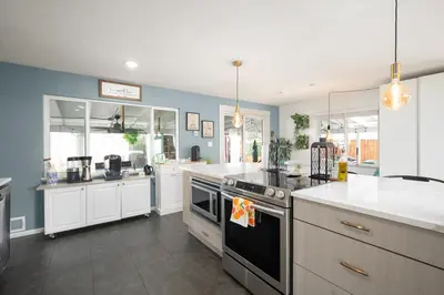 a kitchen with white cabinets and a stove top oven at Luxury 3b-3b- Hot tub, Sauna, Personal Gym in Denver