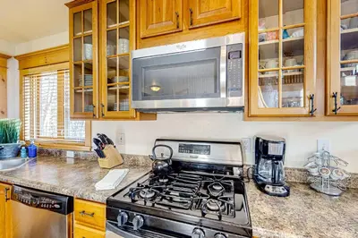 a kitchen with a stove and a microwave at Moose Cabin in Grand Lake