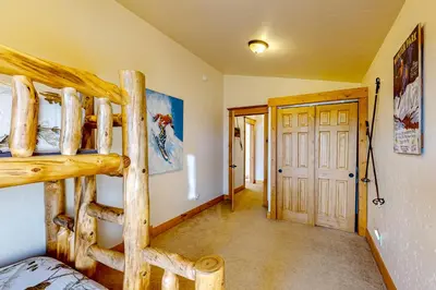 a bedroom with two bunk beds in a room at Moose Cabin in Grand Lake
