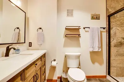 a bathroom with a toilet and a sink and a shower at Winter Park Condo with Sleeping Loft - Near Main St in Winter Park