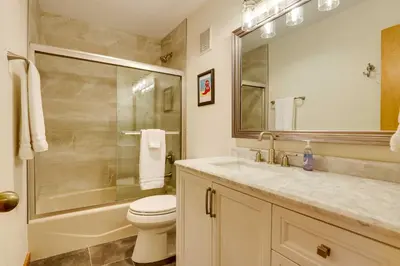 a bathroom with a toilet and a shower and a sink at Winter Park Condo with Sleeping Loft - Near Main St in Winter Park