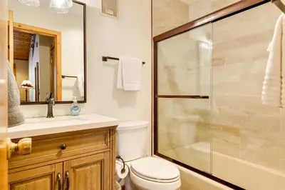 a bathroom with a shower and a toilet and a sink at Winter Park Condo with Sleeping Loft - Near Main St in Winter Park