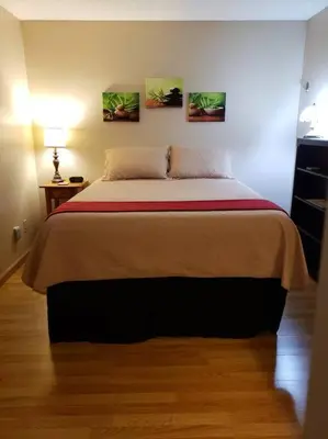 a bedroom with a bed with two pictures on the wall at Entire 1 BR Condo- Near Anschutz, UC Health, DIA- In-Unit Washer Dryer- Seasonal Discounts! in Aurora