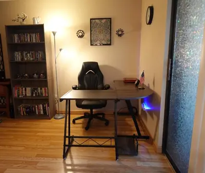 a desk in the corner of a room with a chair at Entire 1 BR Condo- Near Anschutz, UC Health, DIA- In-Unit Washer Dryer- Seasonal Discounts! in Aurora