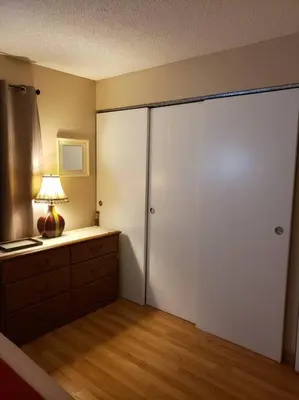a room with a large sliding closet door with a lamp at Entire 1 BR Condo- Near Anschutz, UC Health, DIA- In-Unit Washer Dryer- Seasonal Discounts! in Aurora