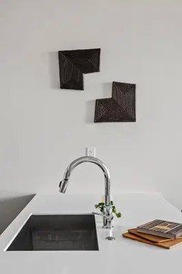 a kitchen sink with a faucet on a counter at Polished Stayscape | Espadin LoHi in Denver