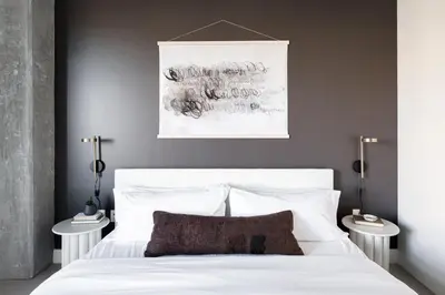 a bedroom with a white bed with two side tables at Relaxed Elegance | Espadin LoHi in Denver