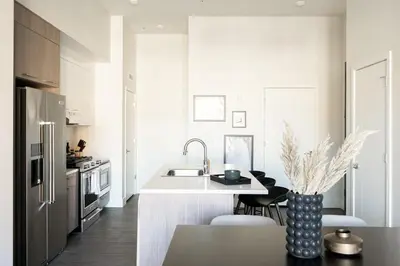 a white kitchen with a sink and a refrigerator at Relaxed Elegance | Espadin LoHi in Denver