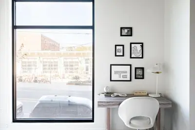 a white room with a window and a white chair at Relaxed Elegance | Espadin LoHi in Denver