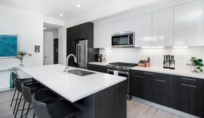 a kitchen with white counters and a large white counter top at Level-Up Elegance | Espadin LoHi in Denver