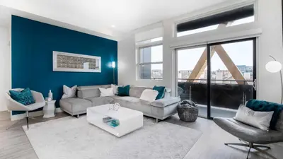 a living room with a couch and a table at Level-Up Elegance | Espadin LoHi in Denver