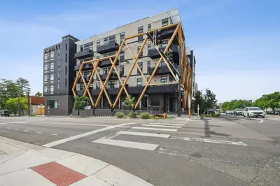 a large building on the corner of a street at Chilltop Lounge | Espadin LoHi in Denver