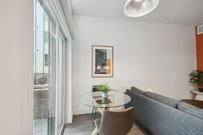 a living room with a couch and a glass table at Southwestern Charm | Espadin LoHi in Denver