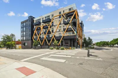 a large building on the corner of a street at Southwestern Charm | Espadin LoHi in Denver