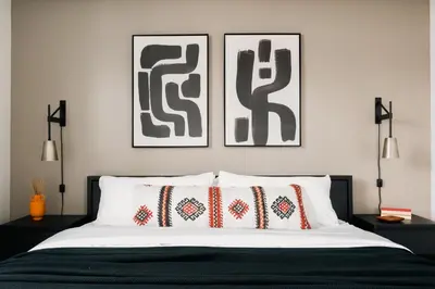 a bedroom with two pictures on the wall above a bed at Rhythm of Night | Espadin LoHi in Denver