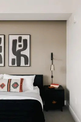 a bedroom with a black and white bed and a table at Rhythm of Night | Espadin LoHi in Denver