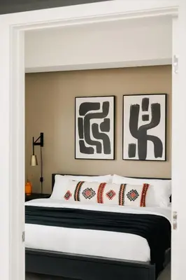 a bedroom with a large white bed with two framed pictures at Rhythm of Night | Espadin LoHi in Denver