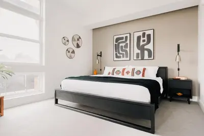a bedroom with a black and white bed and a window at Rhythm of Night | Espadin LoHi in Denver
