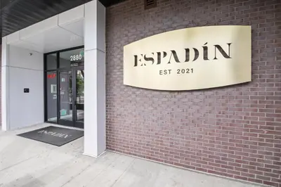 a sign on the side of a brick building at Rhythm of Night | Espadin LoHi in Denver