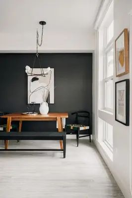 a living room with a table and a black wall at Rhythm of Night | Espadin LoHi in Denver