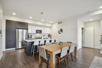 a kitchen with a wooden table and chairs at Sleek & Chic Vibes | Espadin LoHi in Denver