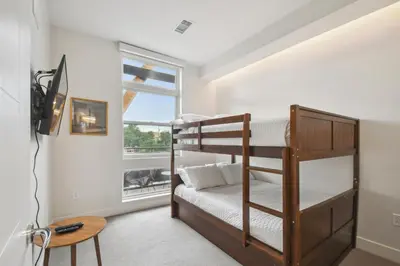 a bedroom with two bunk beds and a window at Sleek & Chic Vibes | Espadin LoHi in Denver