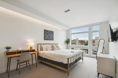 a bedroom with a bed and a desk and a window at Sleek & Chic Vibes | Espadin LoHi in Denver