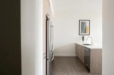 a bathroom with a sink and a refrigerator at Skytop Perspective | Espadin LoHi in Denver