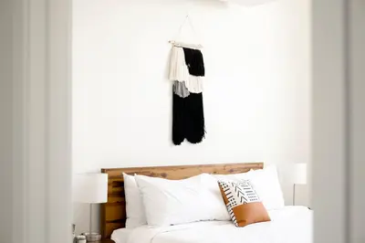 a bedroom with a white bed with white pillows at Skytop Perspective | Espadin LoHi in Denver