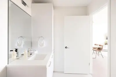 a white bathroom with a sink and a mirror at Skytop Perspective | Espadin LoHi in Denver