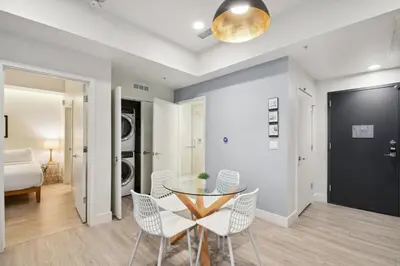 a dining room with a glass table and chairs at Natural Influence | Espadin LoHi in Denver