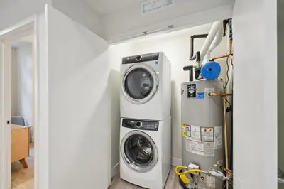 a washing machine and a washer and dryer in a room at Natural Influence | Espadin LoHi in Denver