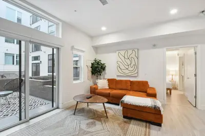 a living room with a couch and a table at Natural Influence | Espadin LoHi in Denver