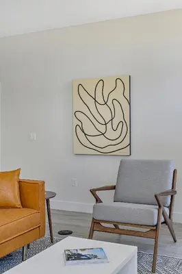 a living room with two chairs and a couch at Lofted Living | Espadin LoHi in Denver