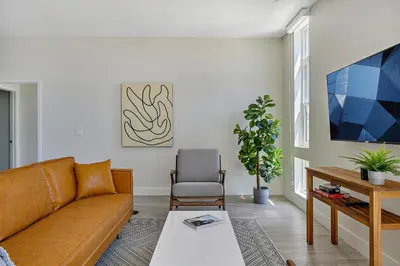a living room with a couch and a table at Lofted Living | Espadin LoHi in Denver